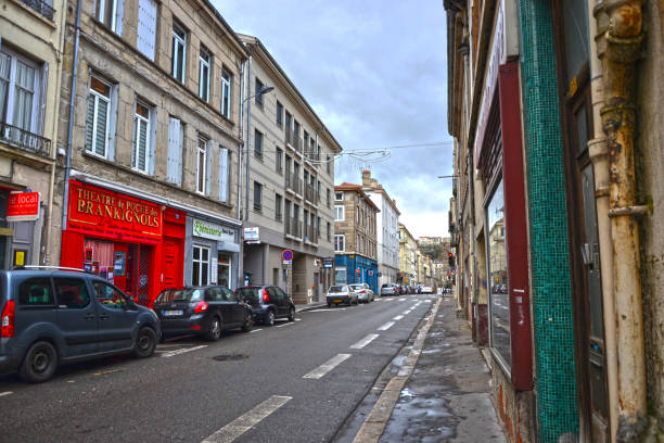 Street view Saint-Etienne, France - January 27th 2020 : View of a street in the city, with a small old theater on the left of the picture (the red facade). saint étienne photos stock pictures, royalty-free photos & images