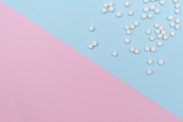 istock Homeopathic globules on double colored pink and blue background, naturopathy concept, copy space 1211195619