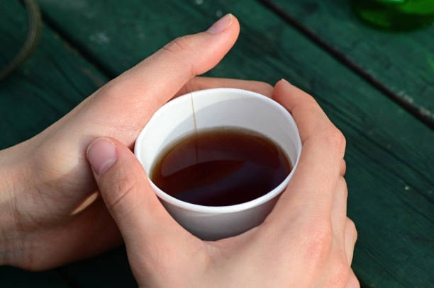 istock Woman holds tea in her hands 1211196106