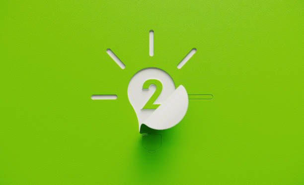istock White Light Bulb Shape with Number Two Folding on Green Background 1211196846