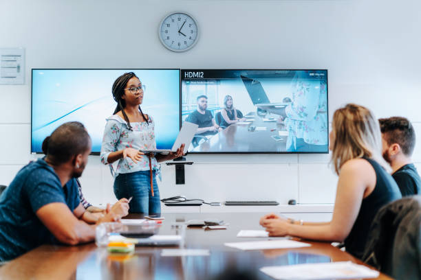 colleagues discussing in meeting room  during video conference - conference call business meeting presentation imagens e fotografias de stock