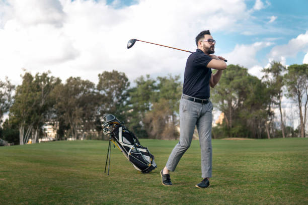istock Portrait of handsome young man teeing off in golf course 1211197309