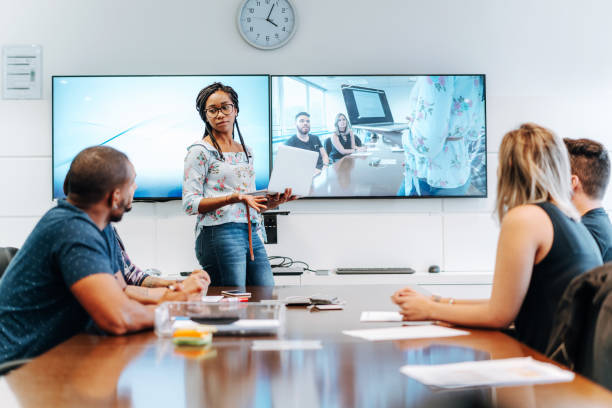 istock Colleagues discussing in meeting room  during video conference 1211197333