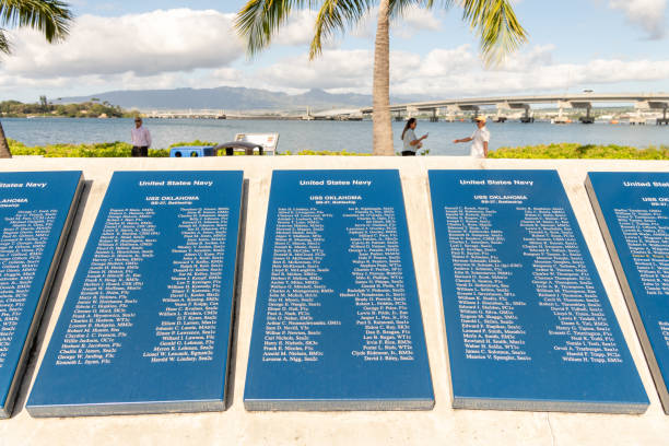 Close up of the names of people who served on the on the battleship USS Oklahoma at the Pearl Harbor Monument. Honolulu, HI / USA - January 27, 2020: Close up of the names of people who served on the on the battleship USS Oklahoma listed on a placard at the Pearl Harbor Monument. pearl harbor stock pictures, royalty-free photos & images