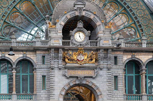 Antwerp / Belgium - October 08 2019: Terminus of railway station Antwerpen Centraal with clock on the door