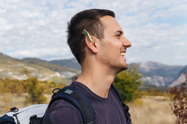 istock Cheerful hiker with a praying mantis on his ear 1211200398