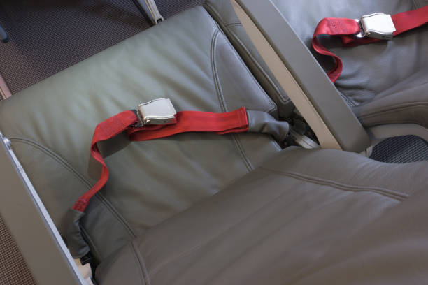 istock Airplane passengers seats with seat belts 1211200486