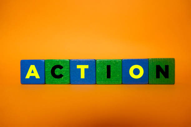 istock ACTION, Wood Blocks on Orange Background. 1211201252