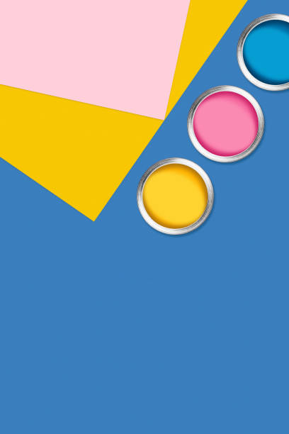 istock Three cans of paint on color background. 1211201787