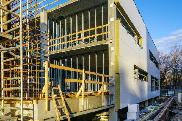 wall assembly of a new building using steel sandwich panels wall assembly of a new modern building using steel sandwich panels sandwich panel photos stock pictures, royalty-free photos & images
