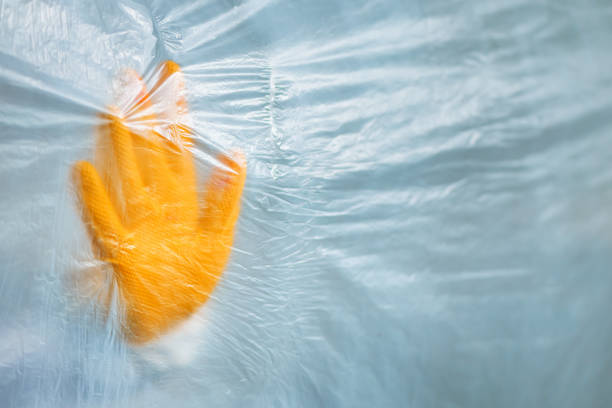 Protective glove behind the plastic curtain in virus quarantine, medical professional epidemiologist fighting the viral outbreak