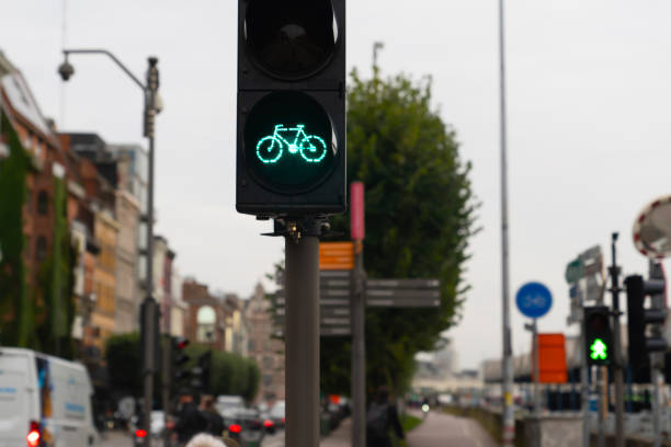 istock Green traffic light for bikes and one biker goes on the lane 1211202937