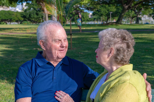 istock Senior couple enjoys a romantic day at the park. Talking. 1211204434