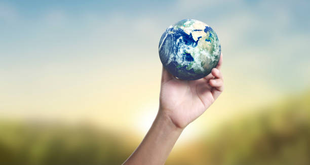 istock Globe ,earth in human hand, holding our planet glowing 1211204466