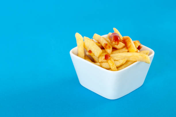 istock french fries in bowl on blue background 1211205106