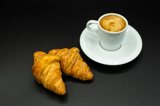 istock Cup of coffee and croissants 1211205306