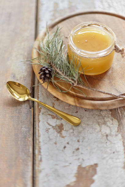 istock Honey jar on vintage wooden table. Top side view with copy space. Selective focus 1211205528