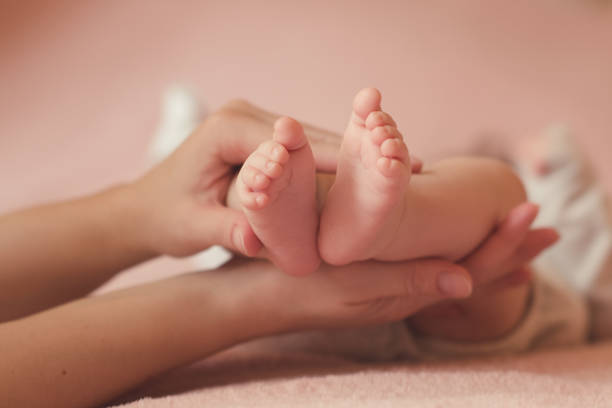 istock Mother holding baby closeup 1211206280