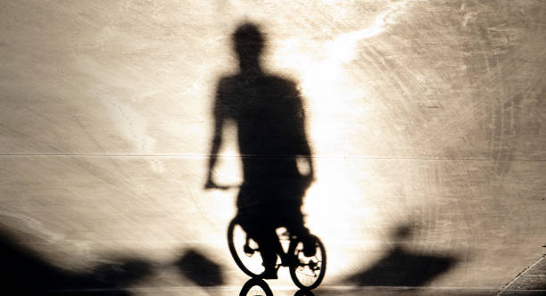 istock Blurry shadow of one young man riding a bike 1211206442