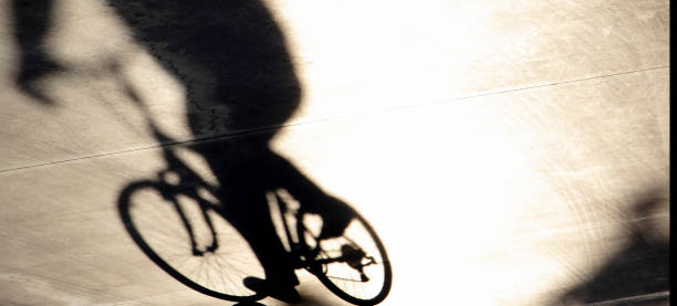 istock Blurry shadow of one young man riding a bike 1211206533