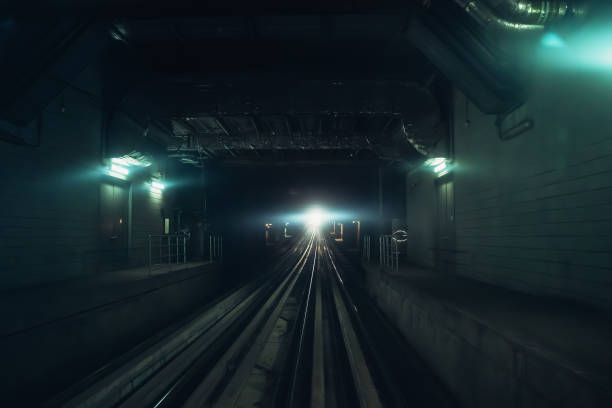 istock Dubai metro tunnel in blurred motion with light in end, view from first wagon, subway tracks 1211206559