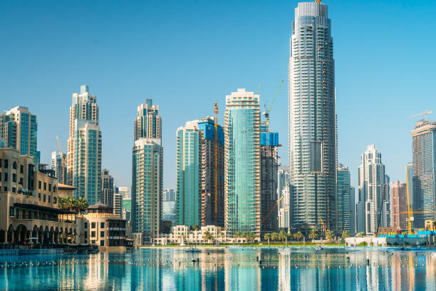 istock Downtown Dubai district skyline panorama with high rise buildings reflected in pool water. United Arab Emirates, UAE 1211209094