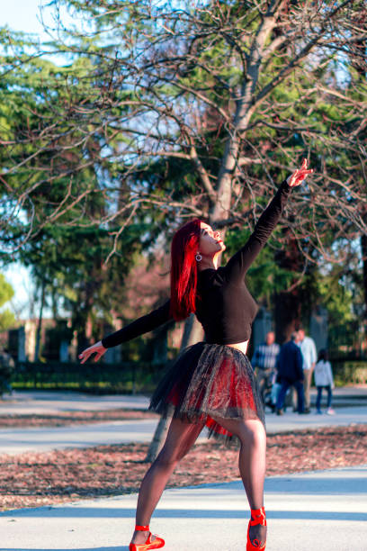 istock Redhead dancer dancing ballet in the Retiro park in Madrid 1211213809