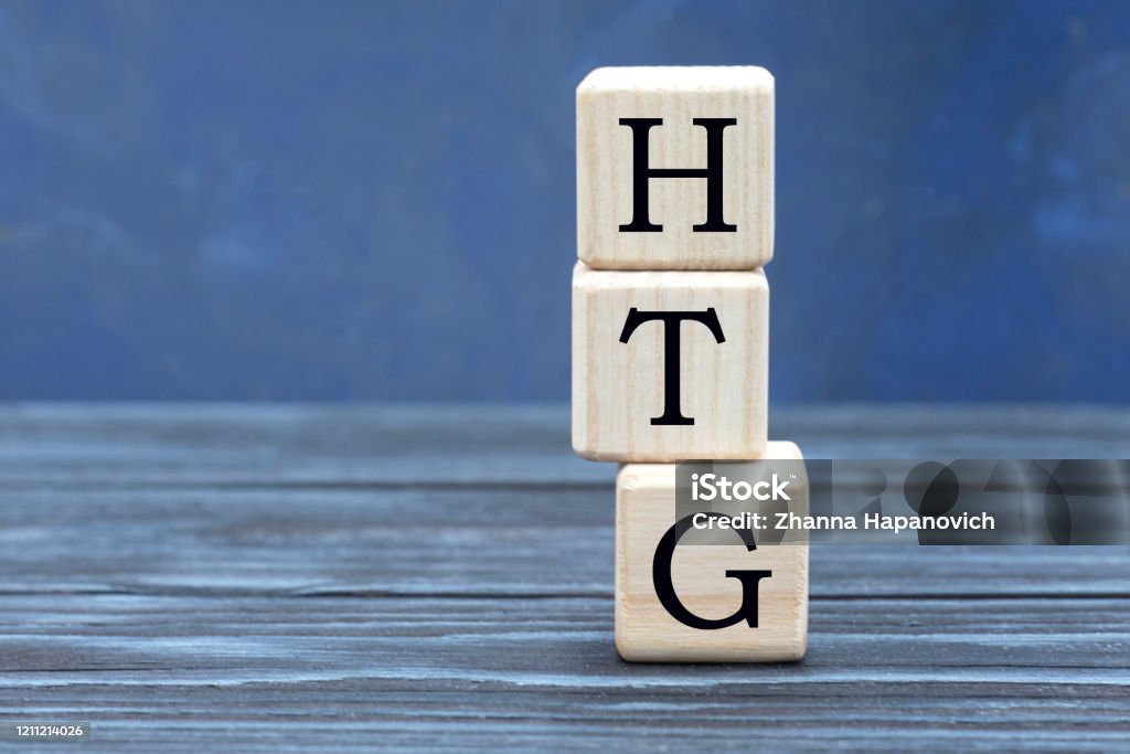 concept word HTG on cubes on a beautiful gray blue background Banking Stock Photo
