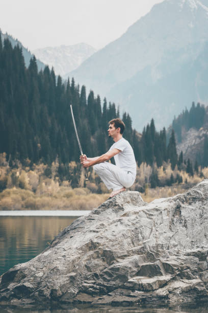 istock A man with a beard lowered his battle sword. Male defeat. 1211214920
