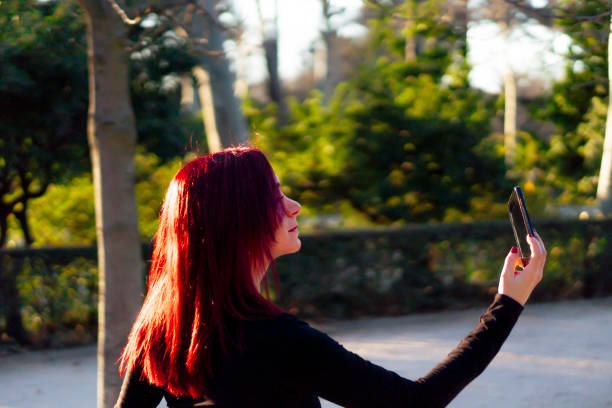 istock Redhead dancer using her smartphone in Madrid's Retiro park 1211215153