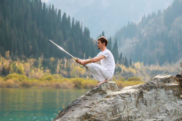 istock A man with a beard lowered his battle sword. Male defeat. 1211216002