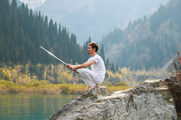 istock A man with a beard lowered his battle sword. Male defeat. 1211216050