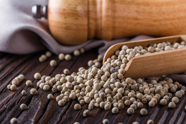 istock white peppercorns in wooden scoop on rustic background 1211217586