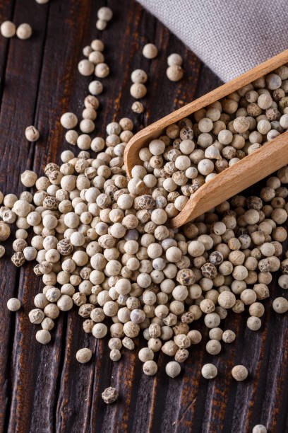 istock white peppercorns in wooden scoop on rustic background 1211217664