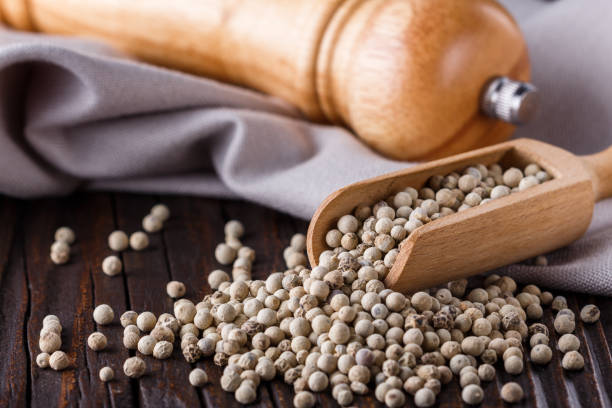 istock white peppercorns in wooden scoop on rustic background 1211217687