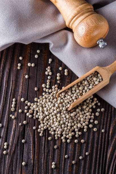 istock white peppercorns in wooden scoop on rustic background 1211217773