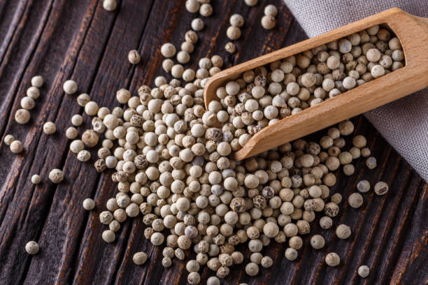 istock white peppercorns in wooden scoop on rustic background 1211217775