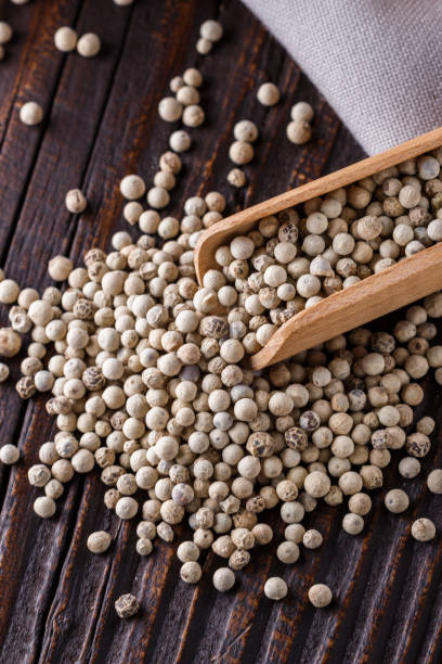 istock white peppercorns in wooden scoop on rustic background 1211217784