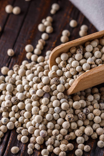istock white peppercorns in wooden scoop on rustic background 1211217786