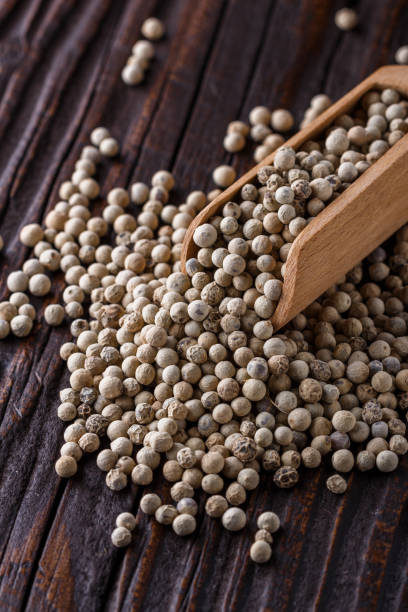 istock white peppercorns in wooden scoop on rustic background 1211217856