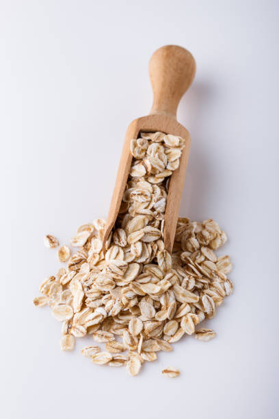 istock raw oat flakes on white acrylic background 1211218796