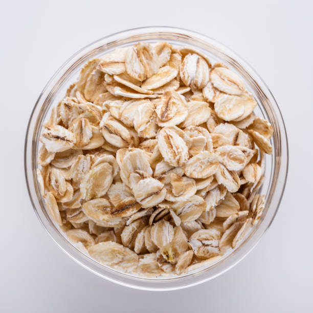 istock raw oat flakes on white acrylic background 1211218869