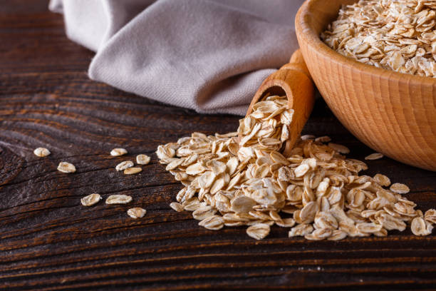 istock raw oatmeal on a wooden rustic background 1211219081