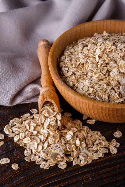 istock raw oatmeal on a wooden rustic background 1211219685