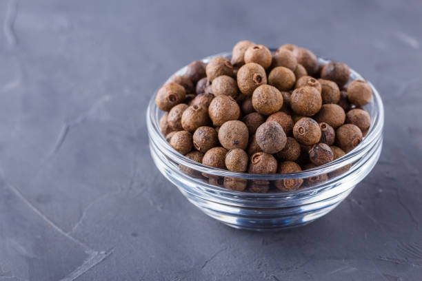 istock fresh spicy peppers allspice on a dark stone background 1211220763
