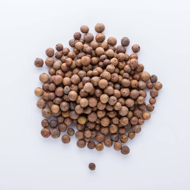 istock fresh spicy peppers allspice on white acrylic background 1211220785
