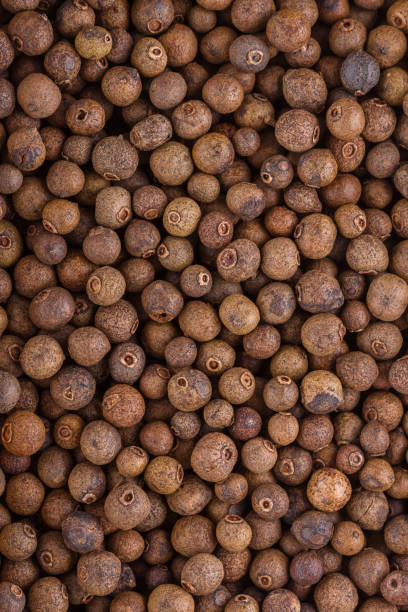 istock fresh spicy peppers allspice on white acrylic background 1211221828