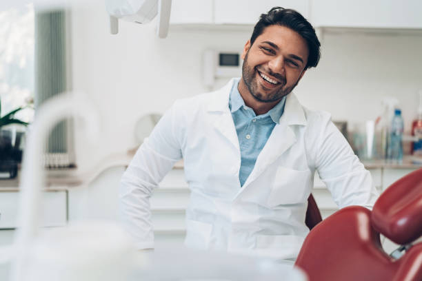 istock Portrait of a smiling dentist 1211227674