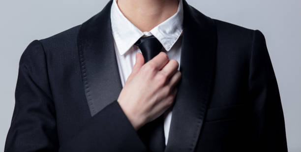 istock business woman adjusts her black tie 1211227862