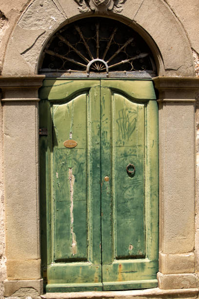 istock Old timber door and arched entrance 1211228920